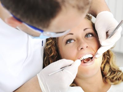 Dentist's teeth checkup with young female, series of related photos